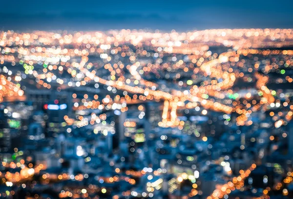 Bokeh of Cape Town skyline from Signal Hill after sunset during the blue hour - South Africa modern city with spectacular nightscape panorama - Blurred defocused night lights