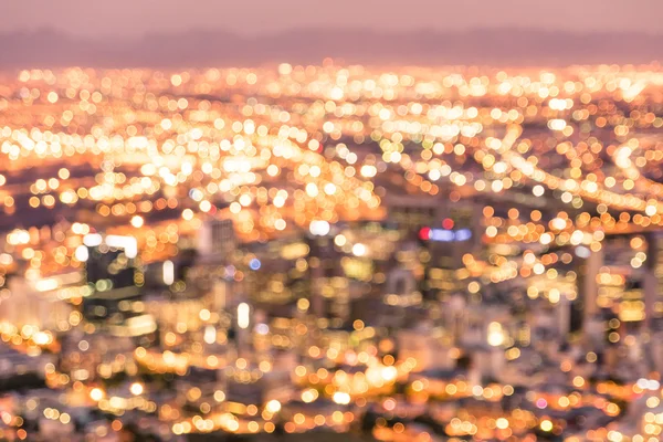 Bokeh of Cape Town skyline from Signal Hill after sunset during the blue hour - South Africa modern city with spectacular nightscape panorama - Warm blurred defocused night lights