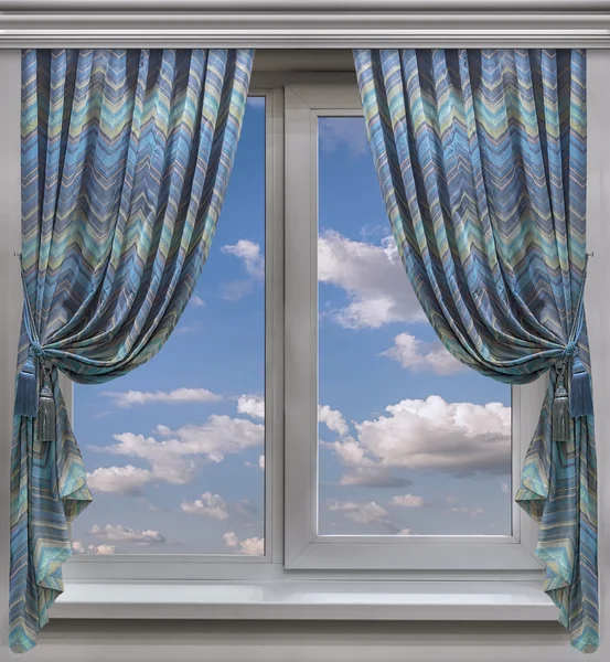 A striped curtains are decorate the window overlooking the blue sky and light clouds