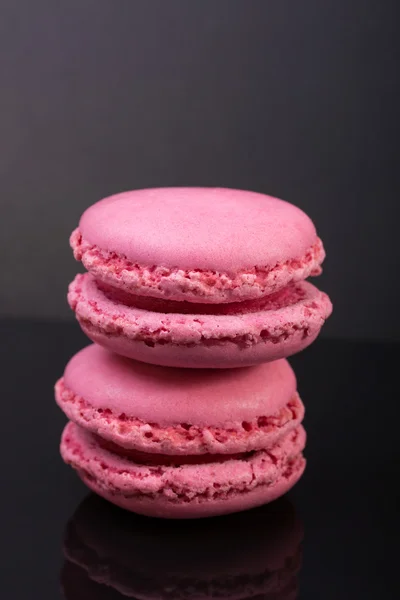 Macarons.french small colored cookies on a black background