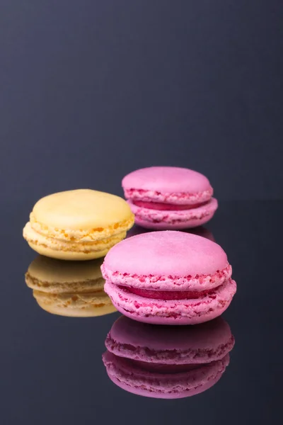 Macarons.French small colored cookies on a black background