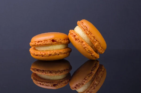 Macarons.French small colored cookies on a black background