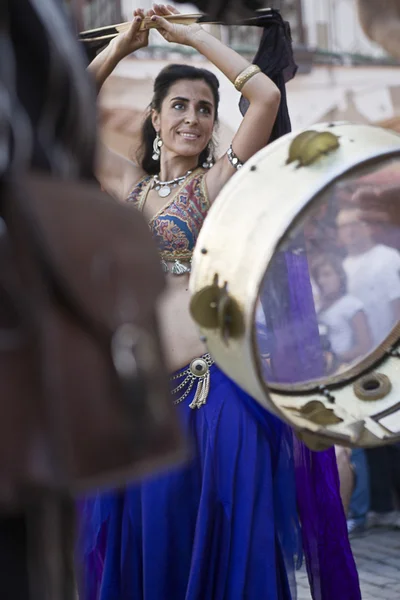 Motion tambourine. Belly dancer and arabic music street band