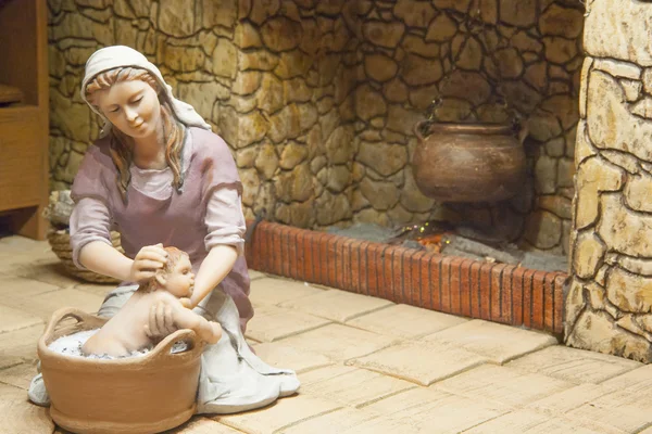 Mary bathes Baby Jesus