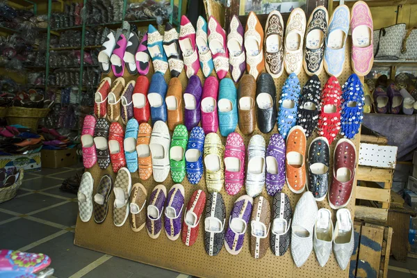 Shoe shop full of leather color shoes at market Tangier,  Morocc