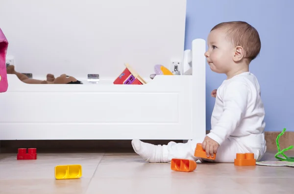 Baby boy playing in his toy room