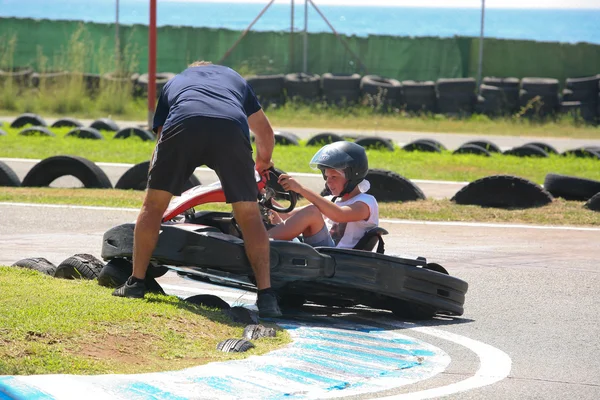 People having fun on a go cart. Out of track help