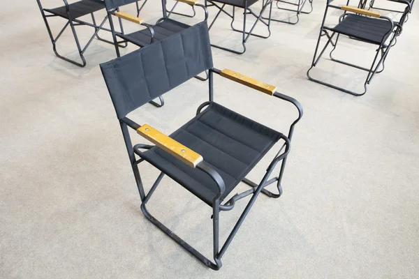 Empty black folding chairs