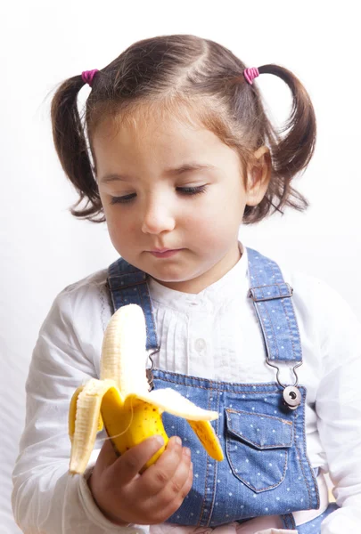 Portrait of happy girl holding a banana