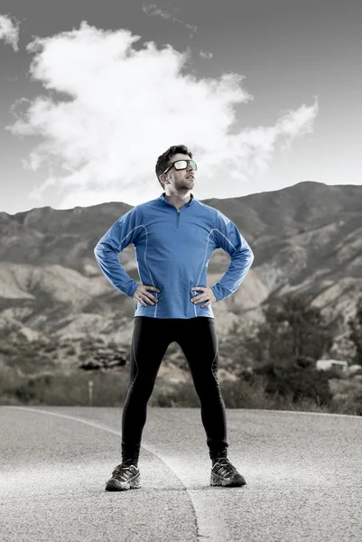 Sport man runner posing on dry desert landscape in fitness healthy lifestyle