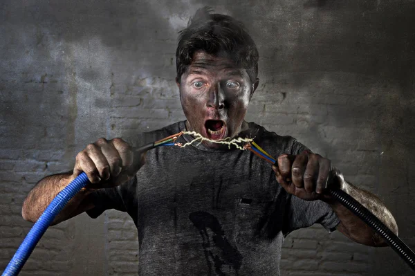 Untrained man joining cable suffering electrical accident with dirty burnt face shock expression