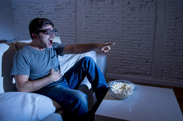 Television addict man on sofa watching TV in fu