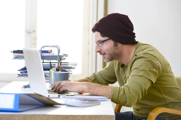 Young attractive hipster businessman working from home office as freelancer self employed business model