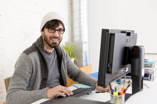 Attractive man hipster trendy style businessman working home office with desktop computer