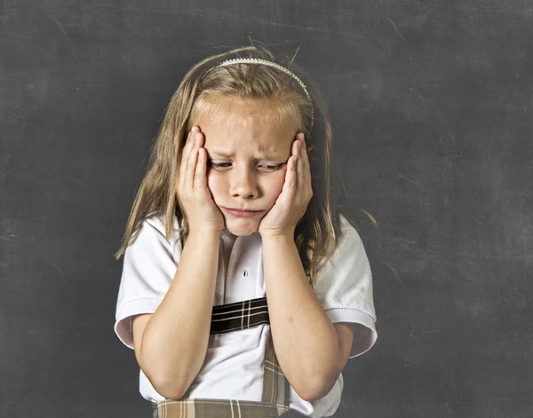 Sweet junior schoolgirl crying sad in children education stress and bullying victim