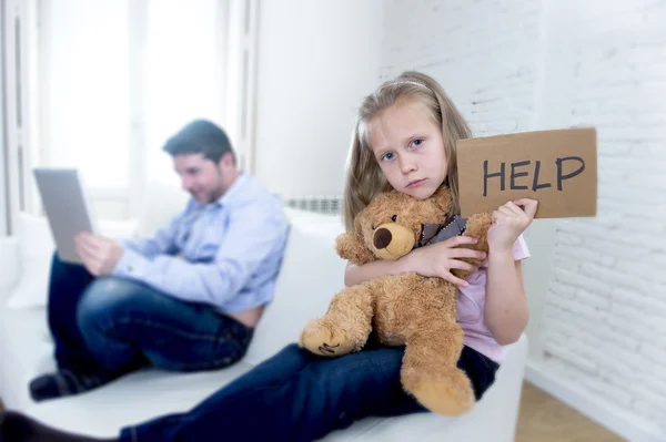 internet addict father using digital tablet pad ignoring little sad daughter bored hugging teddy bear