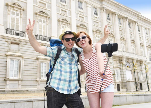 Young American couple enjoying Spain holiday trip taking selfie photo self portrait with mobile phone
