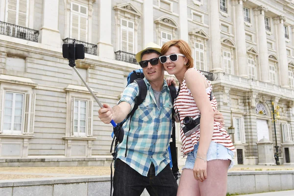 Young American couple enjoying Spain holiday trip taking selfie photo self portrait with mobile phone