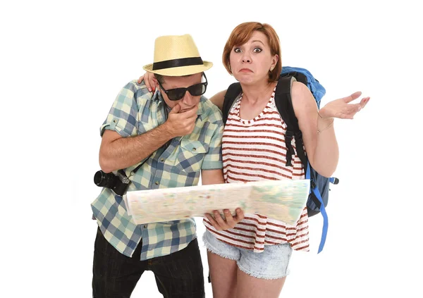 Young tourist couple reading city map looking lost and confused loosing orientation with girl carrying travel backpack