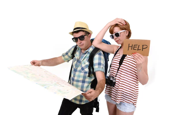 Young tourist couple reading city map looking lost and confused loosing orientation with girl carrying travel backpack