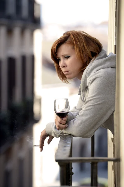 Attractive woman suffering depression and stress outdoors at the balcony