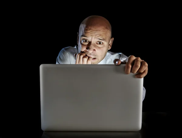 Addict man at computer laptop watching porn internet addiction concept