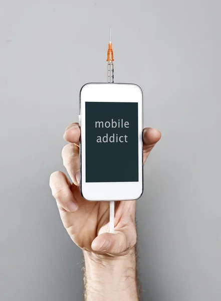 Internet cellphone addict man holding mobile phone with syringe in addiction concept