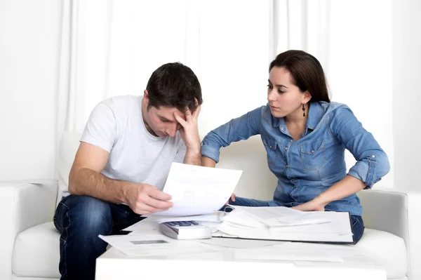 Young couple worried at home in stress accounting bank payments