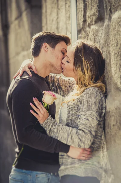 Beautiful couple in love kissing on street alley celebrating Valentines day