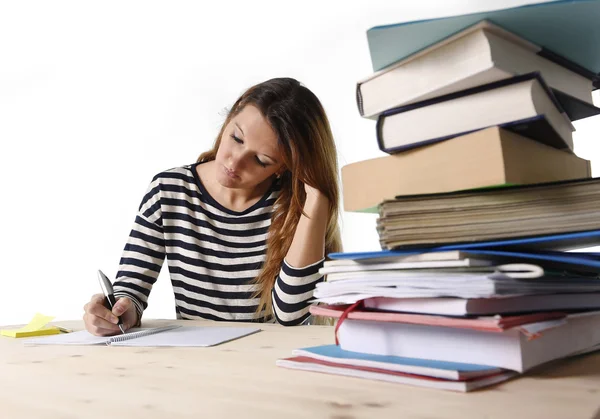 Young student girl concentrated studying for exam at college library education concept