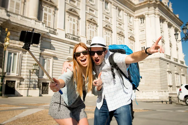 Beautiful friends tourist couple visiting Spain in holidays students exchange taking selfie picture