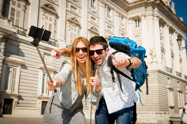 Beautiful friends tourist couple visiting Spain in holidays students exchange taking selfie picture