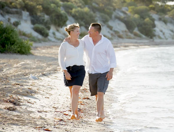 Attractive beautiful  couple in love walking on the beach in romantic summer holidays
