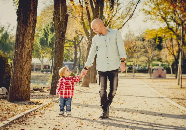 Young father and his beautiful little 2 years old son walking together