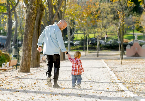 Young father and his beautiful little 2 years old son walking together