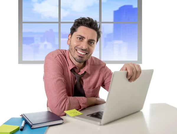 Young successful businessman working on computer happy at business district office
