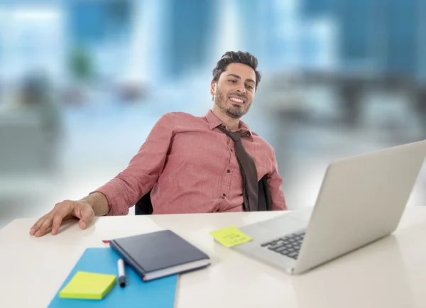 Businessman working at office computer happy satisfied and successful