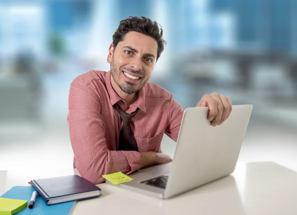 Businessman working at office computer happy satisfied and successful
