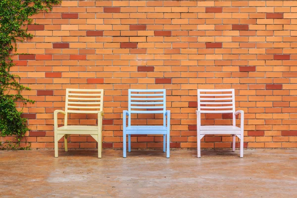 Red brick wall with chairs