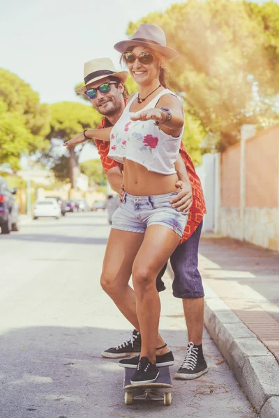 Couple playing with skateboard