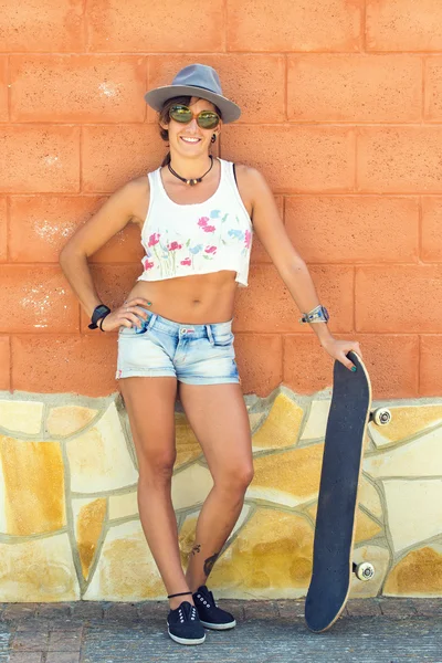 Woman laughing with Skateboard on the street