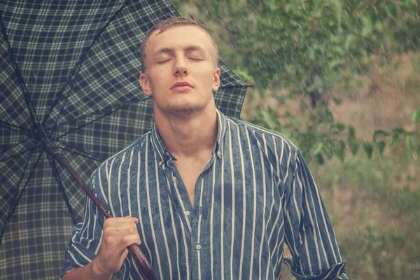 Sexy young man wet in rain