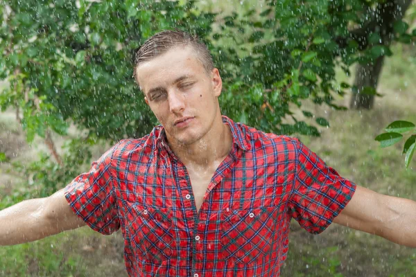 Sexy young man wet in rain
