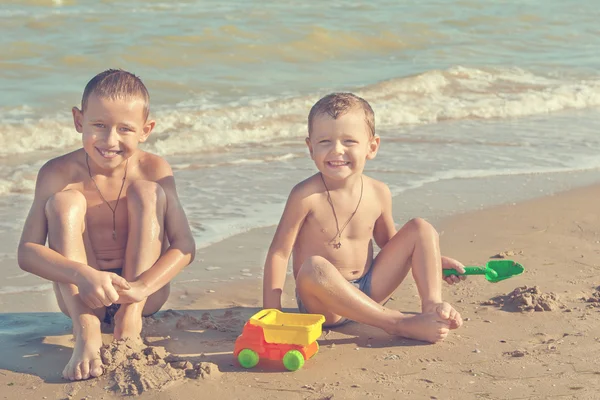 Happy  Children - two boys having fun on the beach