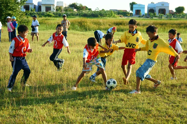 Asian kid playing football, physical education
