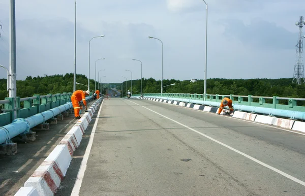 Asian worker working, traffic paint street