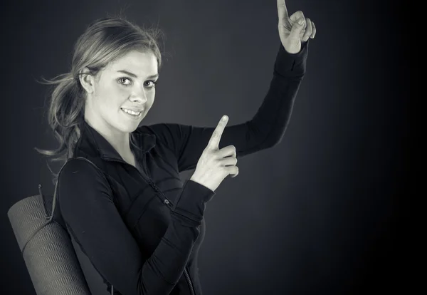 Woman looking at camera and pointing with fingers