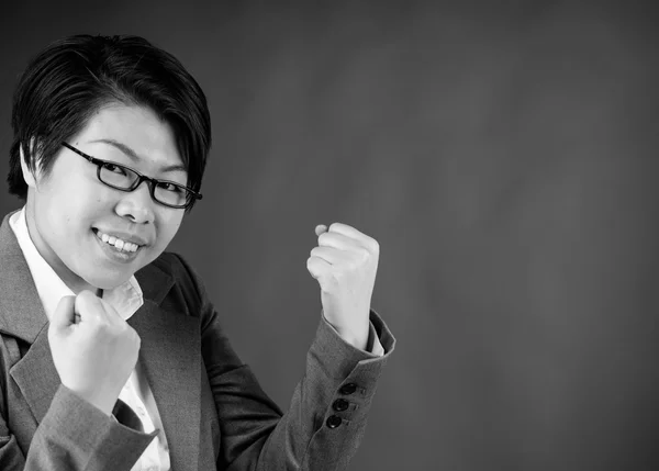 Woman celebrating success with fists up