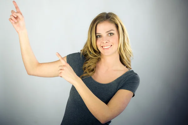 Woman looking at camera and pointing with fingers