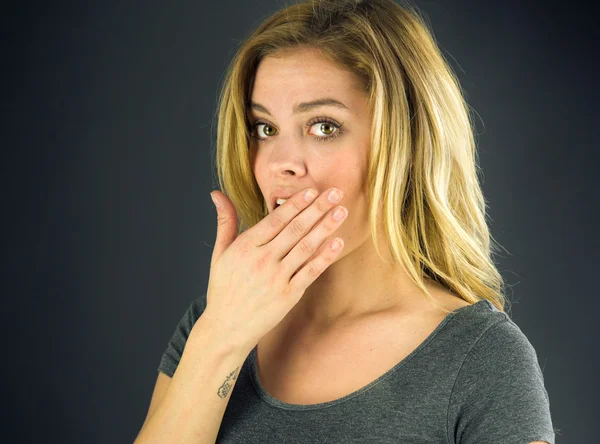 Shocked woman covering her mouth by hand